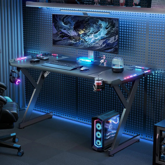LED gaming desk setup with monitor, RGB lighting, and gaming accessories for an immersive gaming experience.